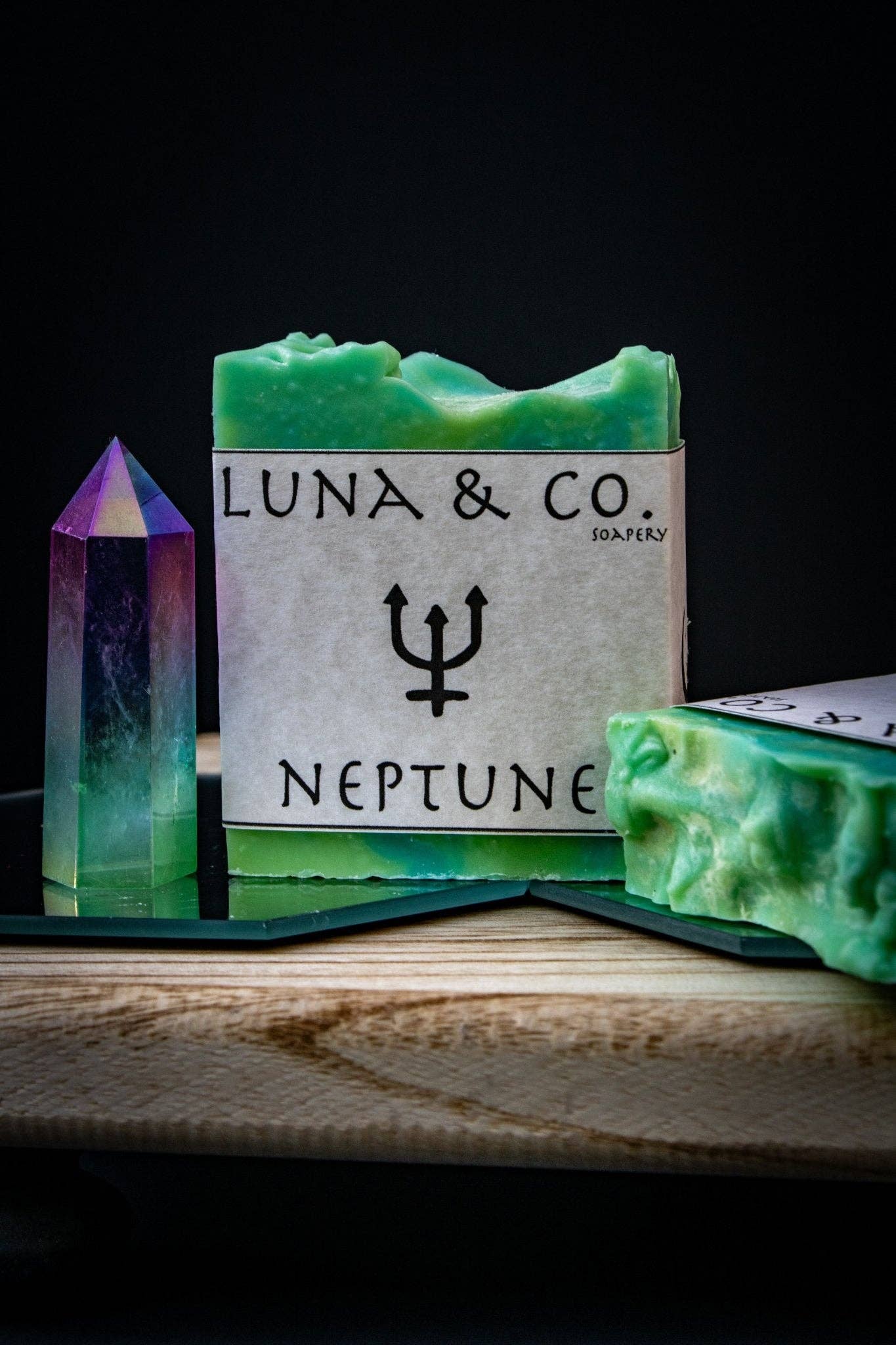 Green soap bar with 'Luna & Co.' branding and a crystal on a dark background