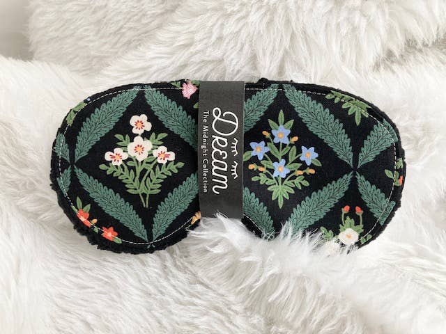Sleep mask with floral pattern on a fluffy white surface