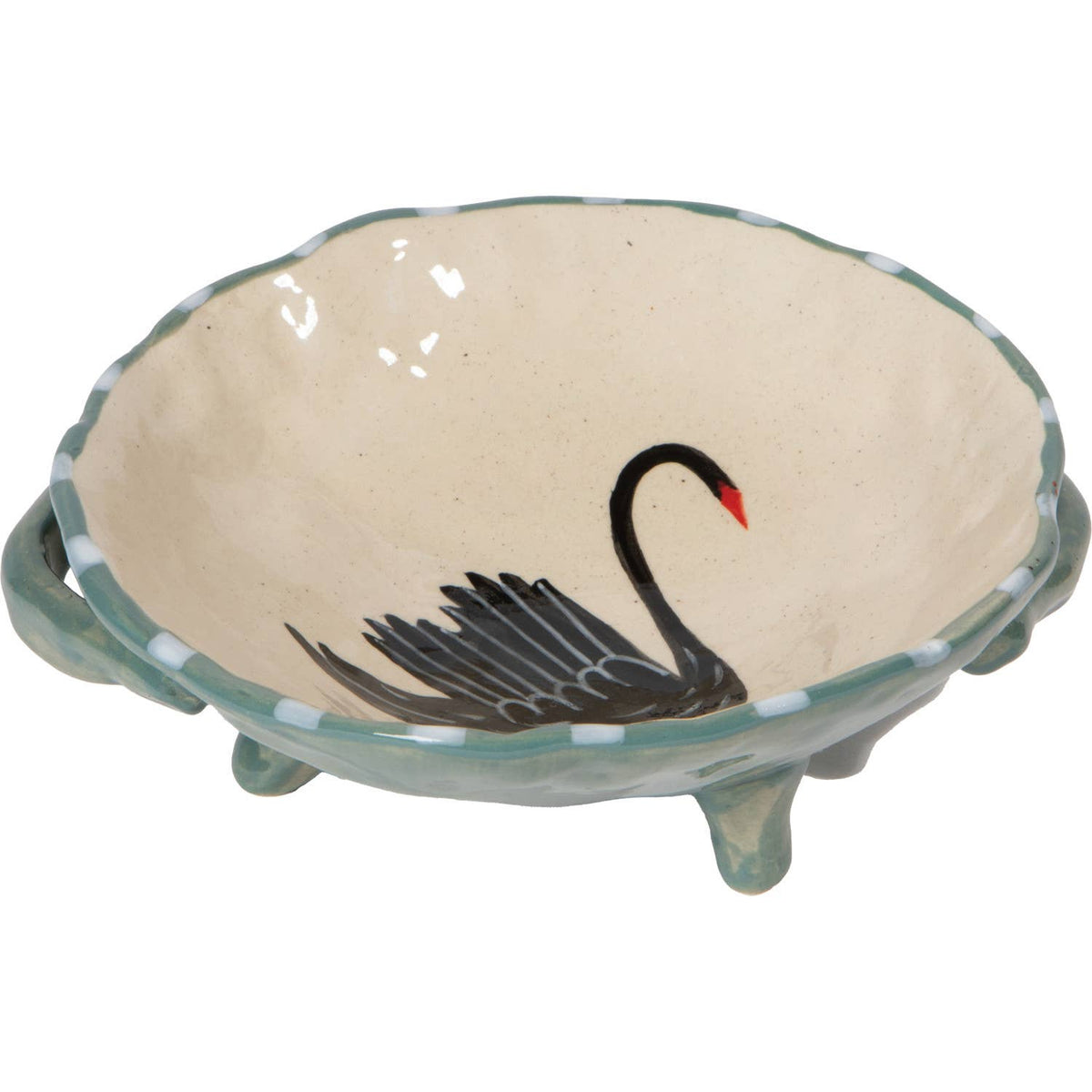 Ceramic bowl with a black swan design on a beige background