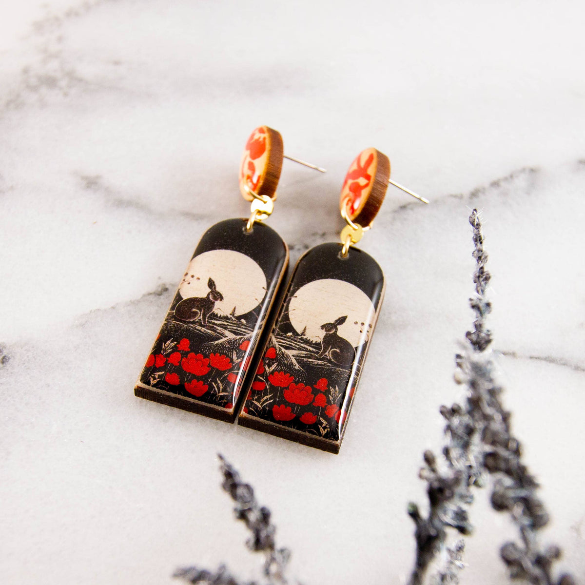 Pair of earrings with artistic design on a marble surface