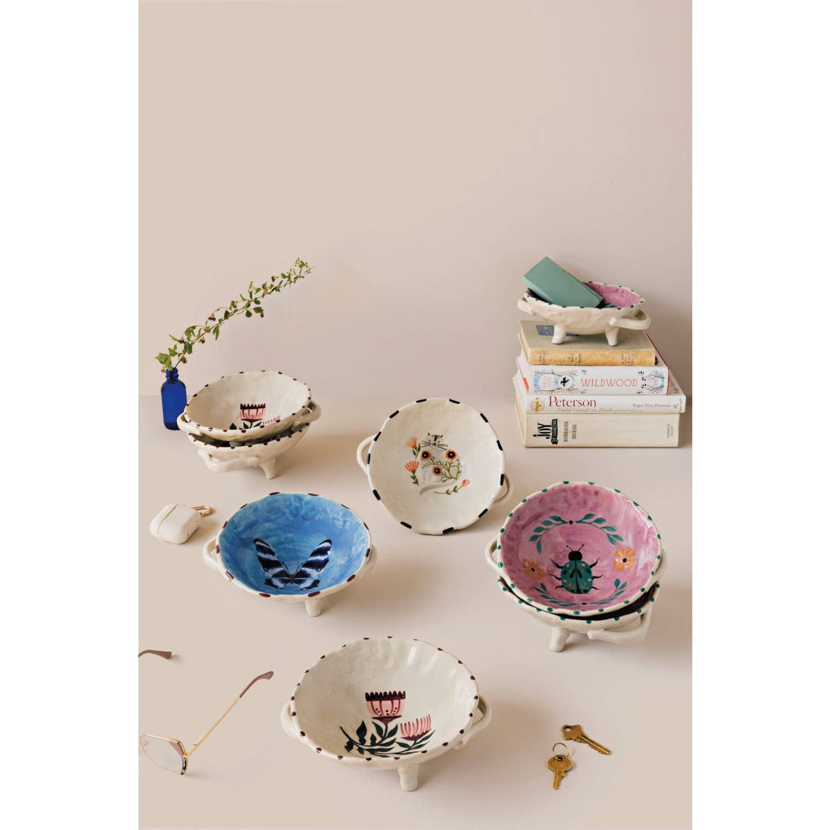 Set of small decorative bowls with floral patterns on a neutral background