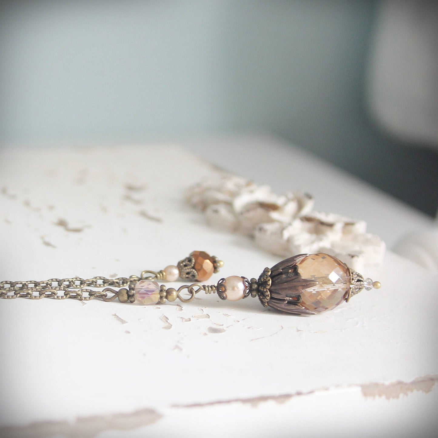 Pendulum with decorative beads on a textured surface