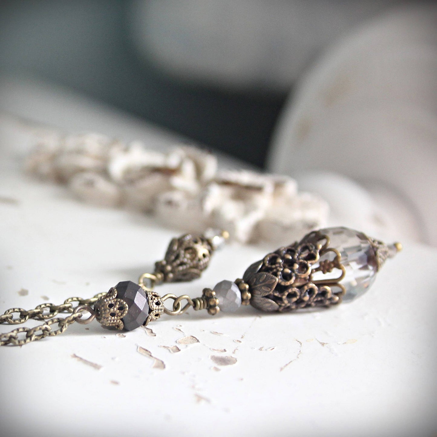Pendulum with decorative beads on a light surface