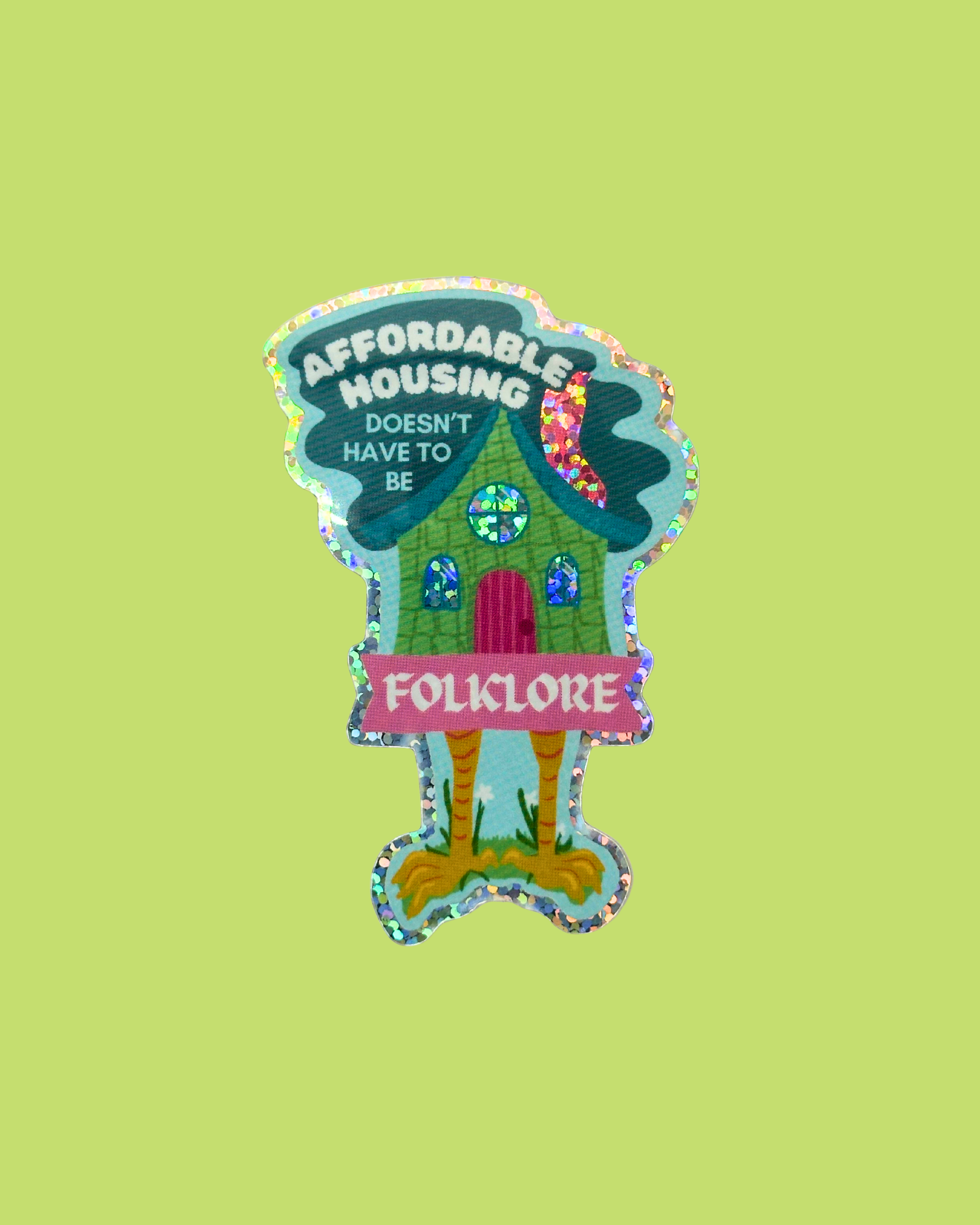 Colorful illustration of Baba Yaga's house with 'Affordable Housing Doesn't Have to Be Folklore' text on a green background
