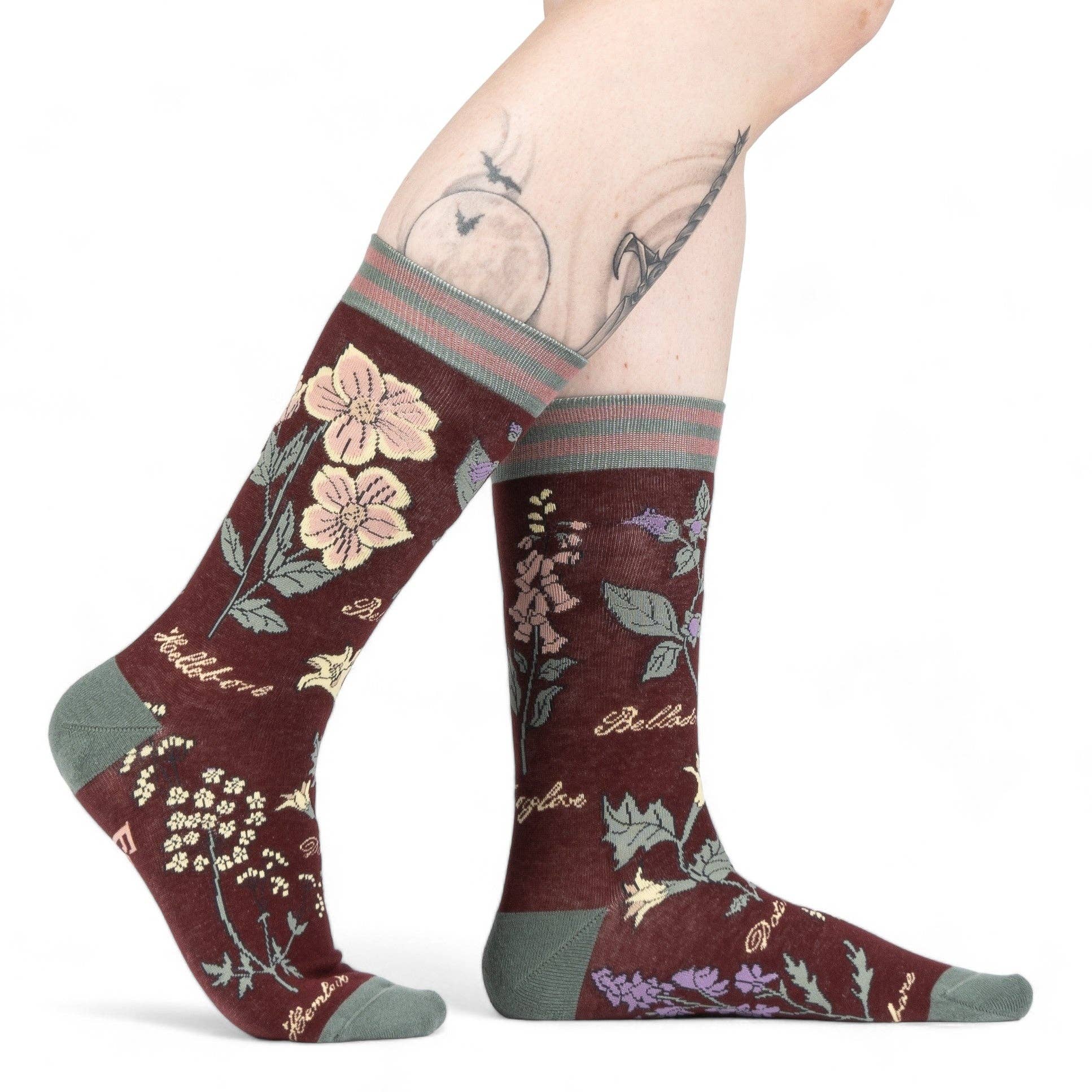 Floral-patterned socks worn by a person on a white background
