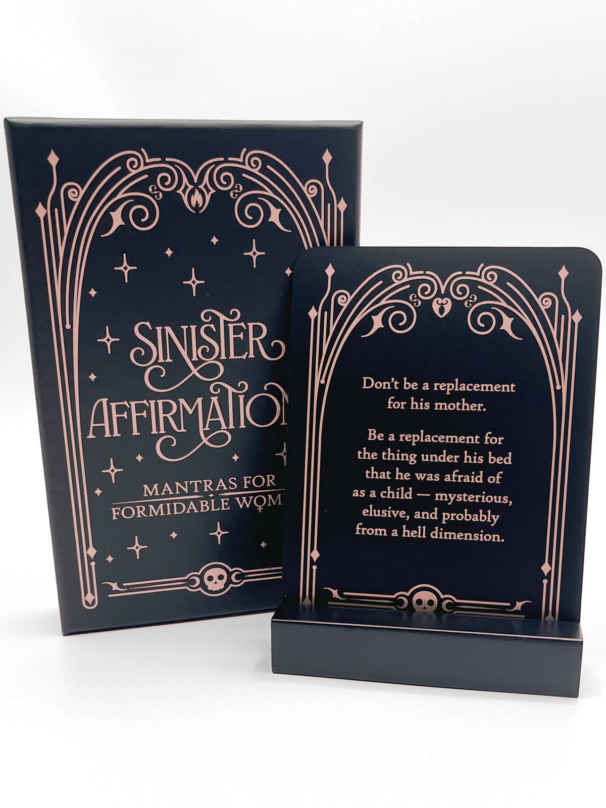 Black card with decorative rose gold text on a white background