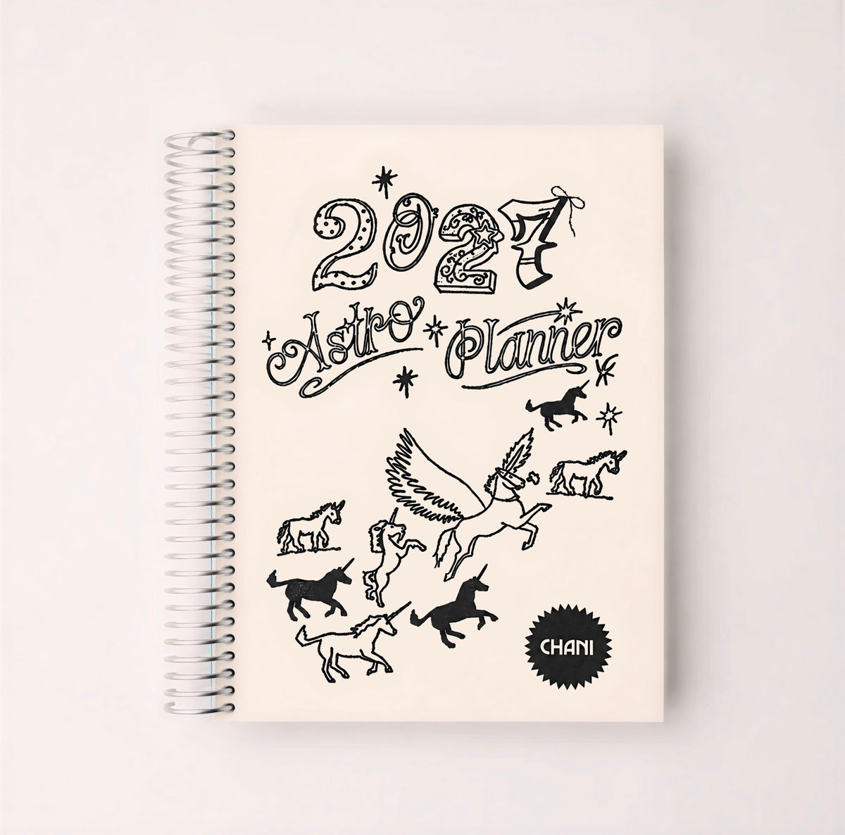A spiral-bound 2024 Astro Planner with a cream-colored cover featuring black line art illustrations of zodiac animals and the text '2024 Astro Planner' and 'CHANI'.