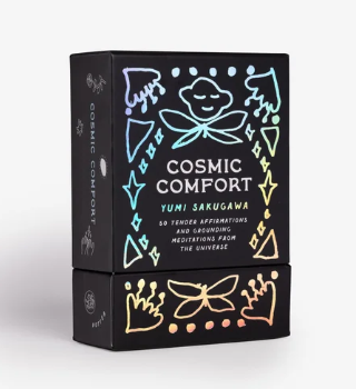 Black box titled 'Cosmic Comfort' by Yumi Sakugawa with decorative elements on a white background