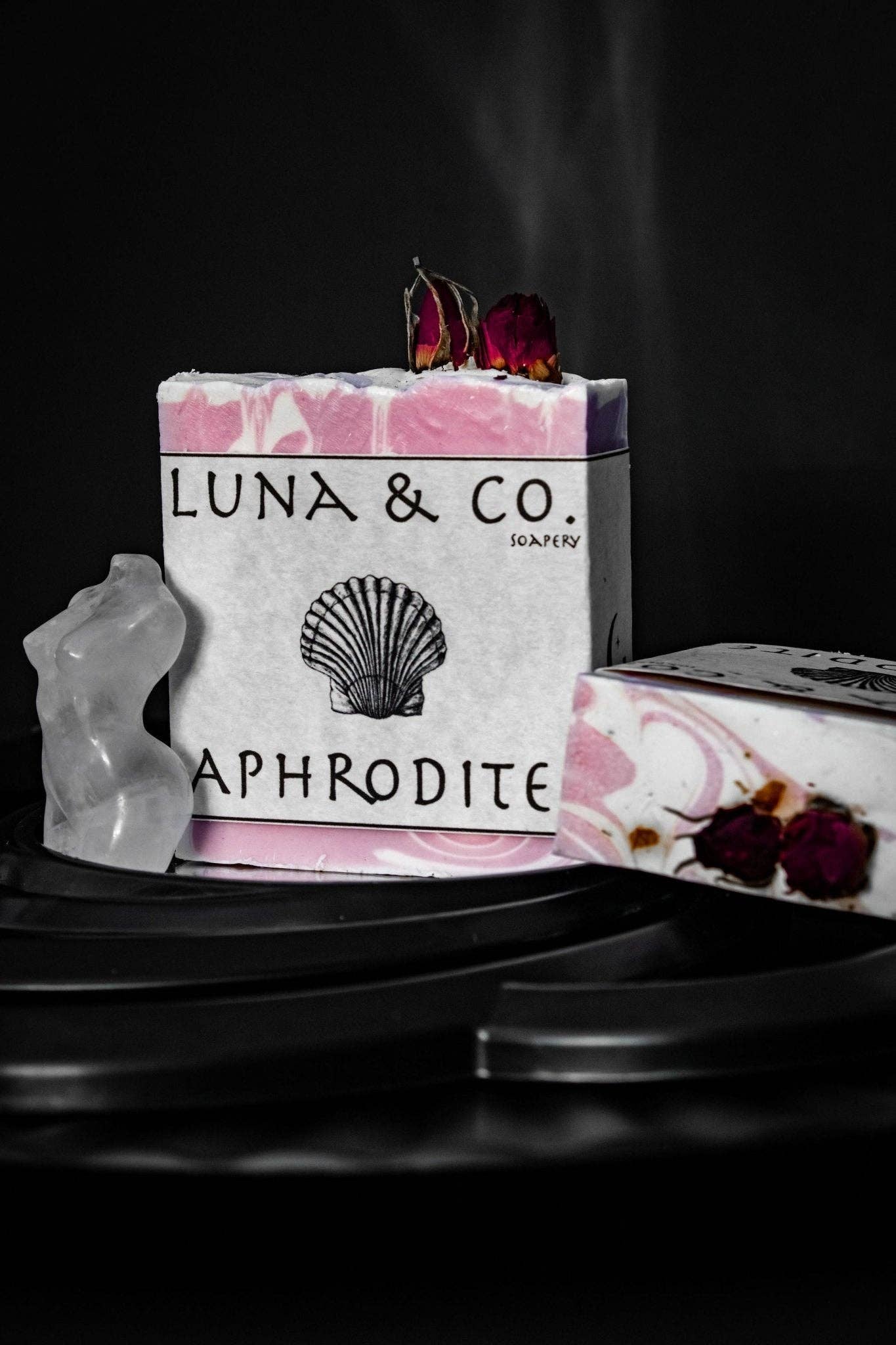 Luna & Co. soap with floral design on a dark background