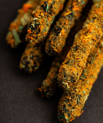 Close-up of all-natural incense sticks on a black background.