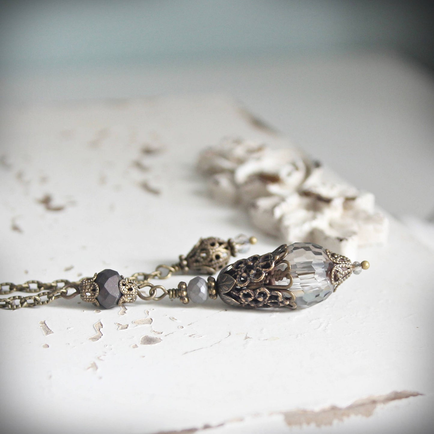 Pendulum with decorative beads on a textured surface