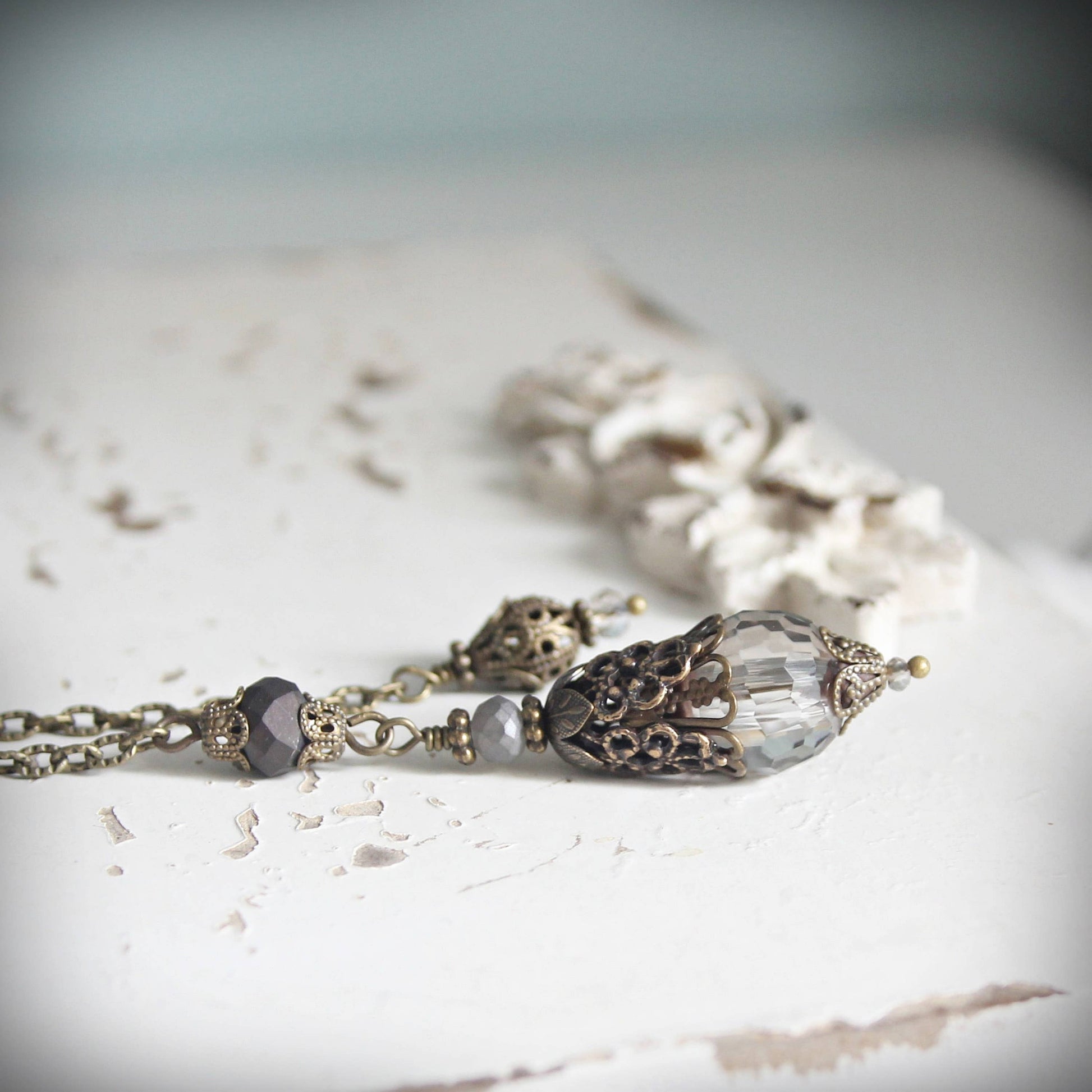 Pendulum with decorative beads on a textured surface