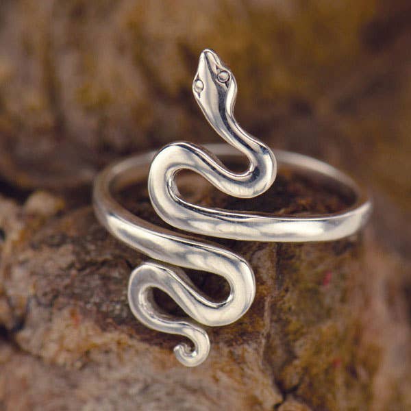 Silver snake-shaped ring on a stone background