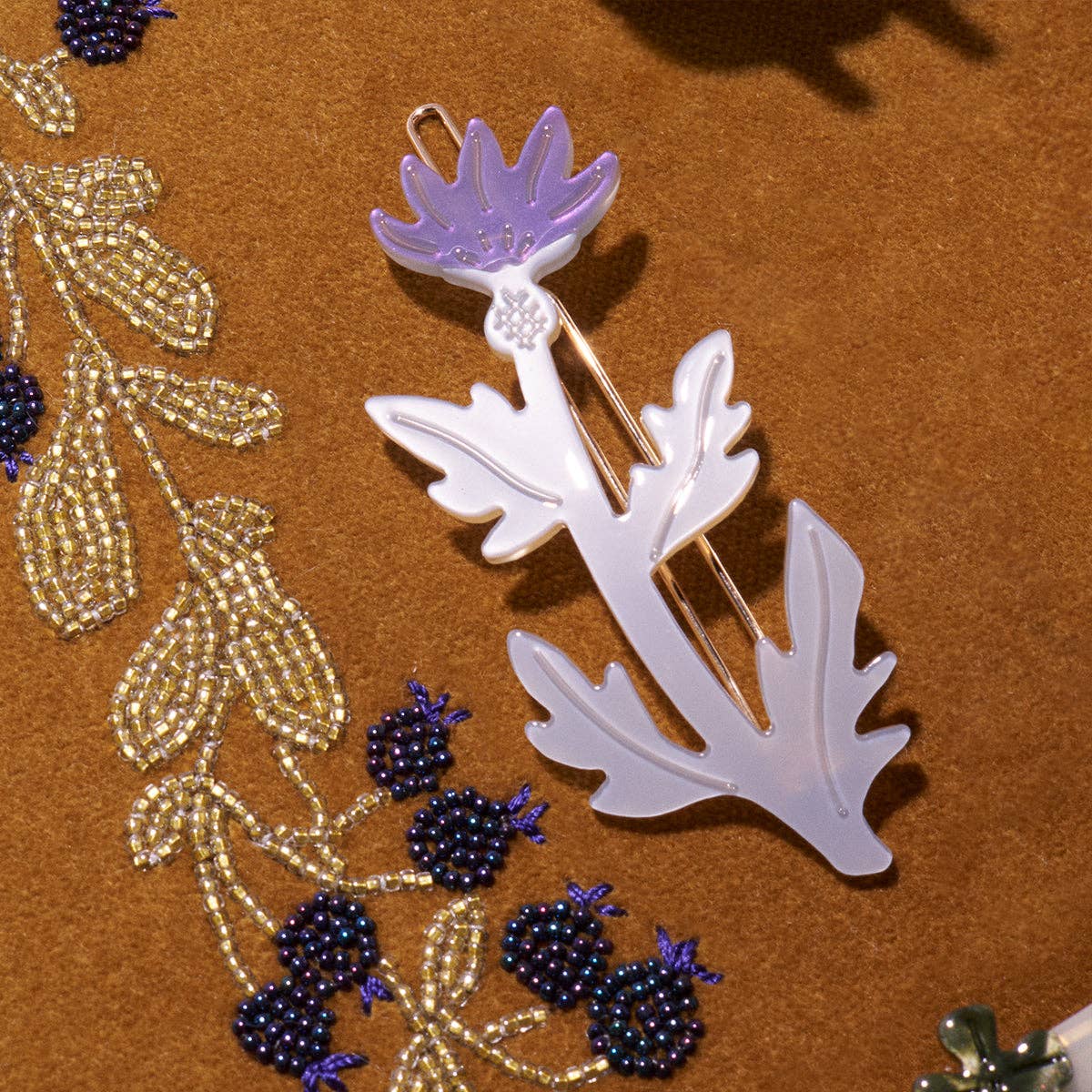 Decorative brooch with floral design on a brown background