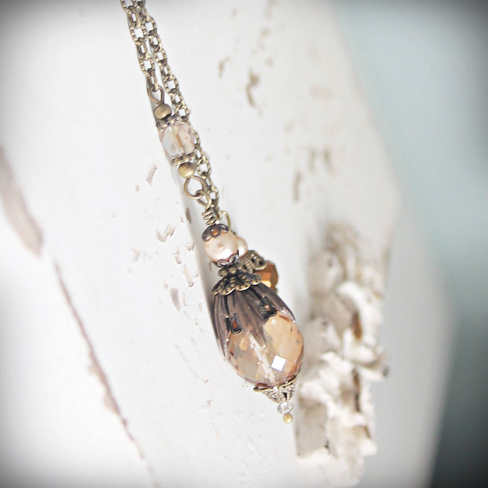 Pendulum with a decorative pendant on a blurred background