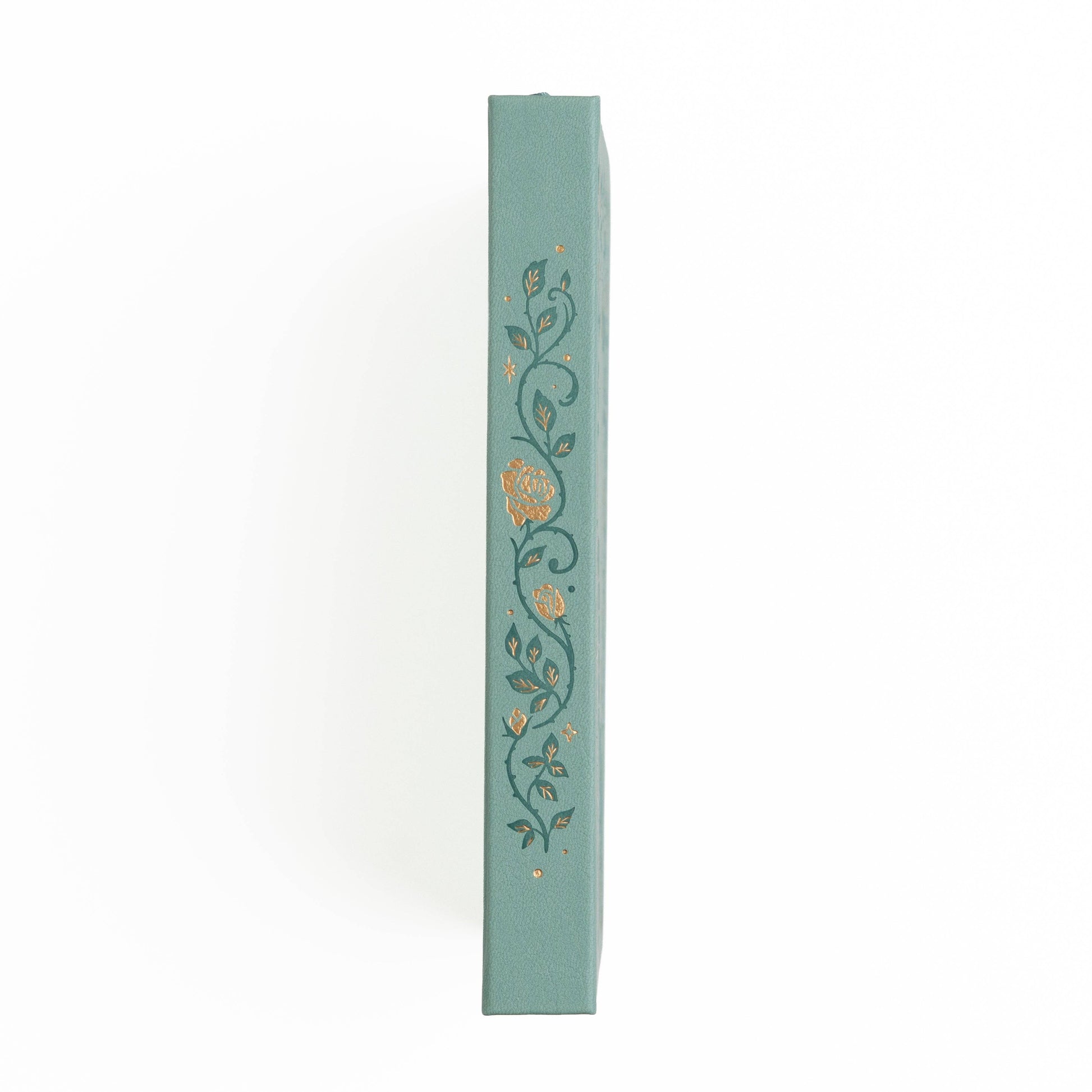 Teal book with floral design on a white background