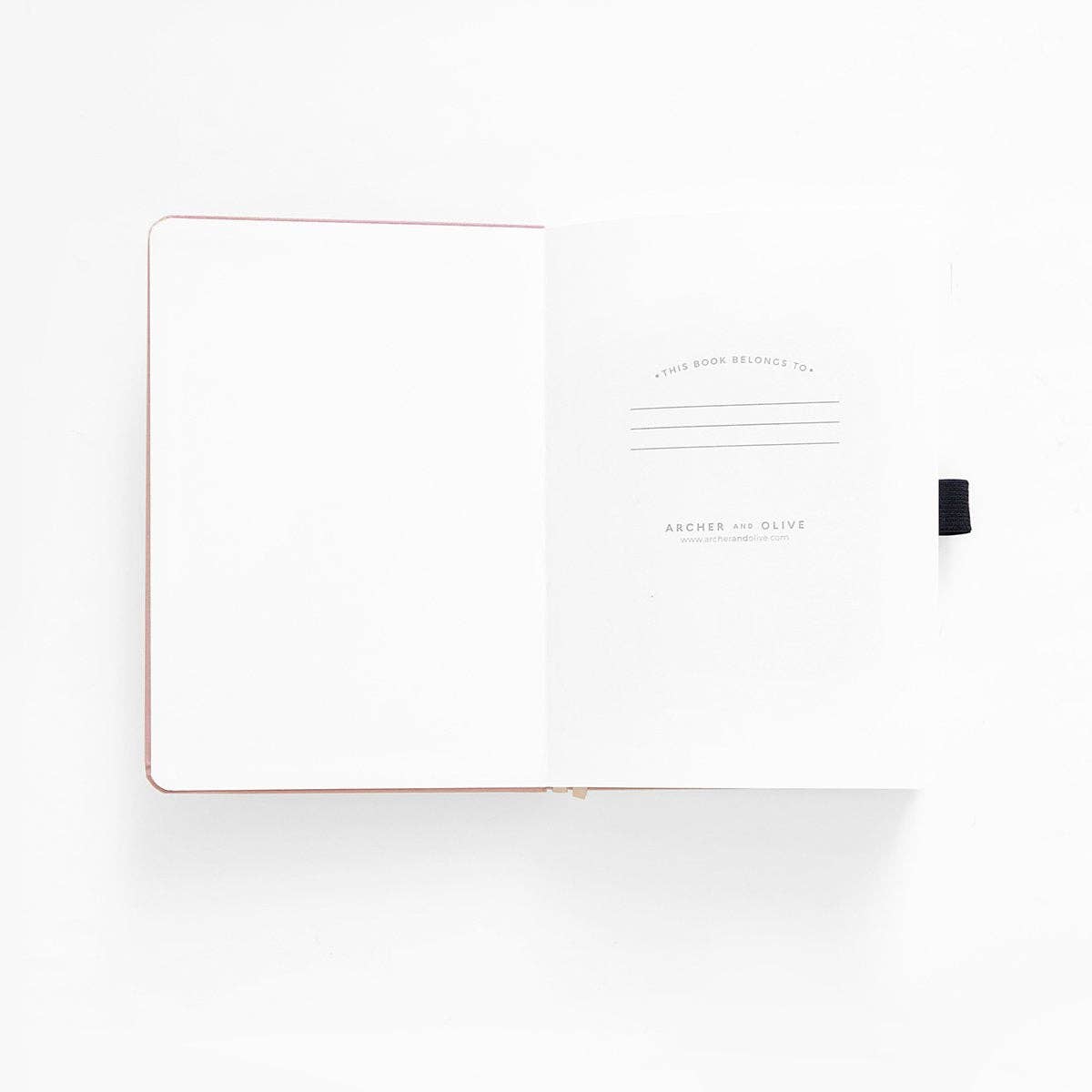 White notebook with black pen on a white background