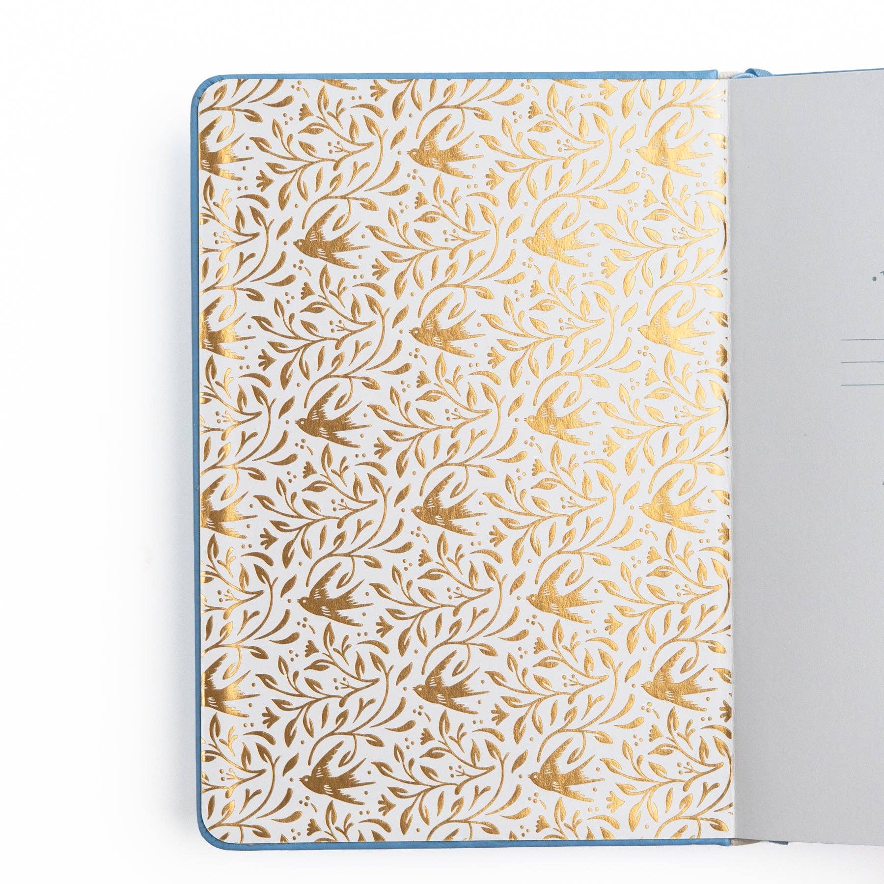 Notebook with gold floral pattern on white background