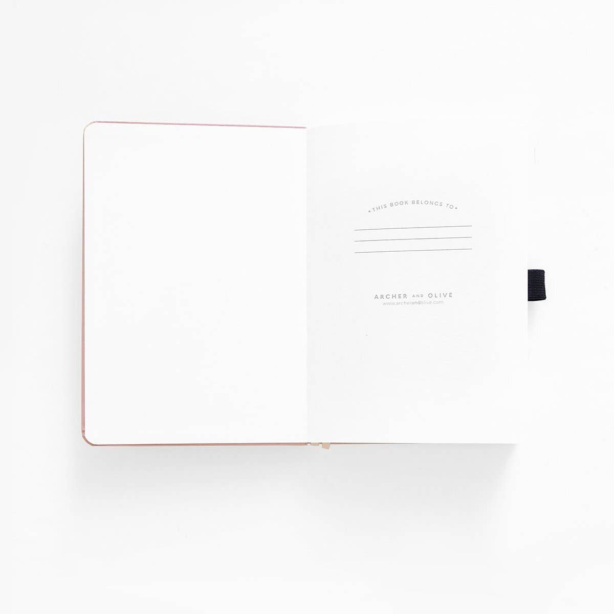 White notebook with black pen on a white background