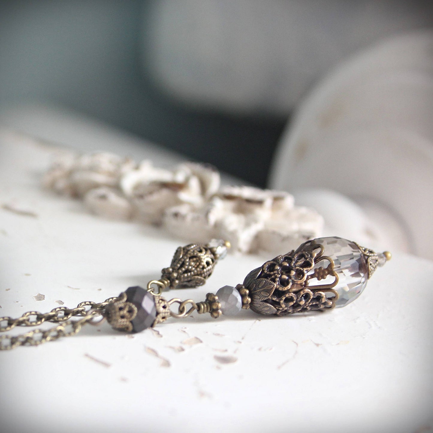 Pendulum with decorative beads on a light surface