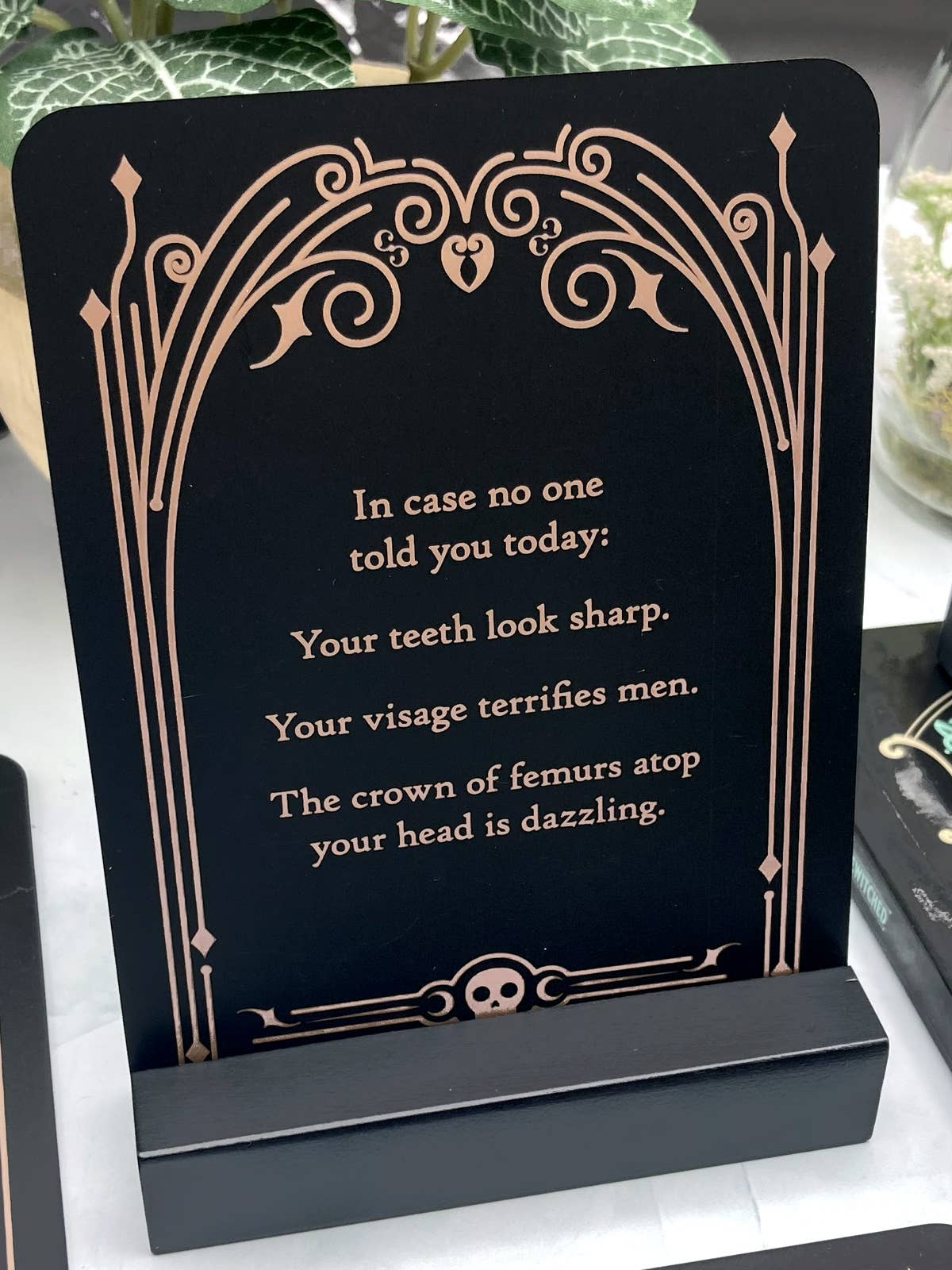 Decorative sign with humorous text on a stand
