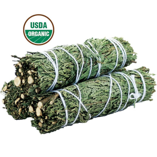 Two bundles of dried herbs tied together with a USDA Organic label on a white background