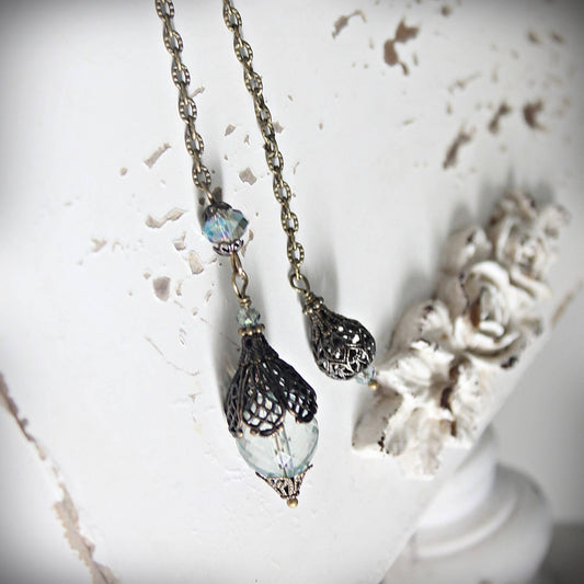 Pendulum with decorative beads on a textured white surface