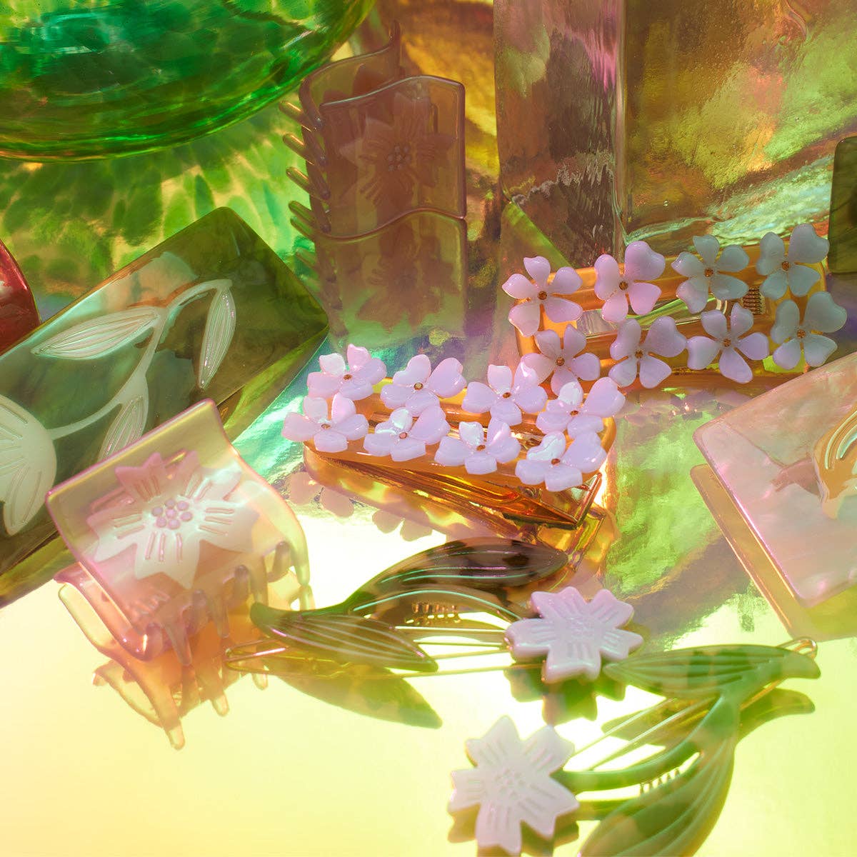 Colorful hair clips with floral designs on a vibrant background