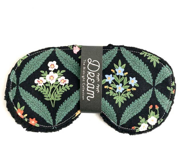 Floral patterned eye mask with 'Dream' brand label on a white background