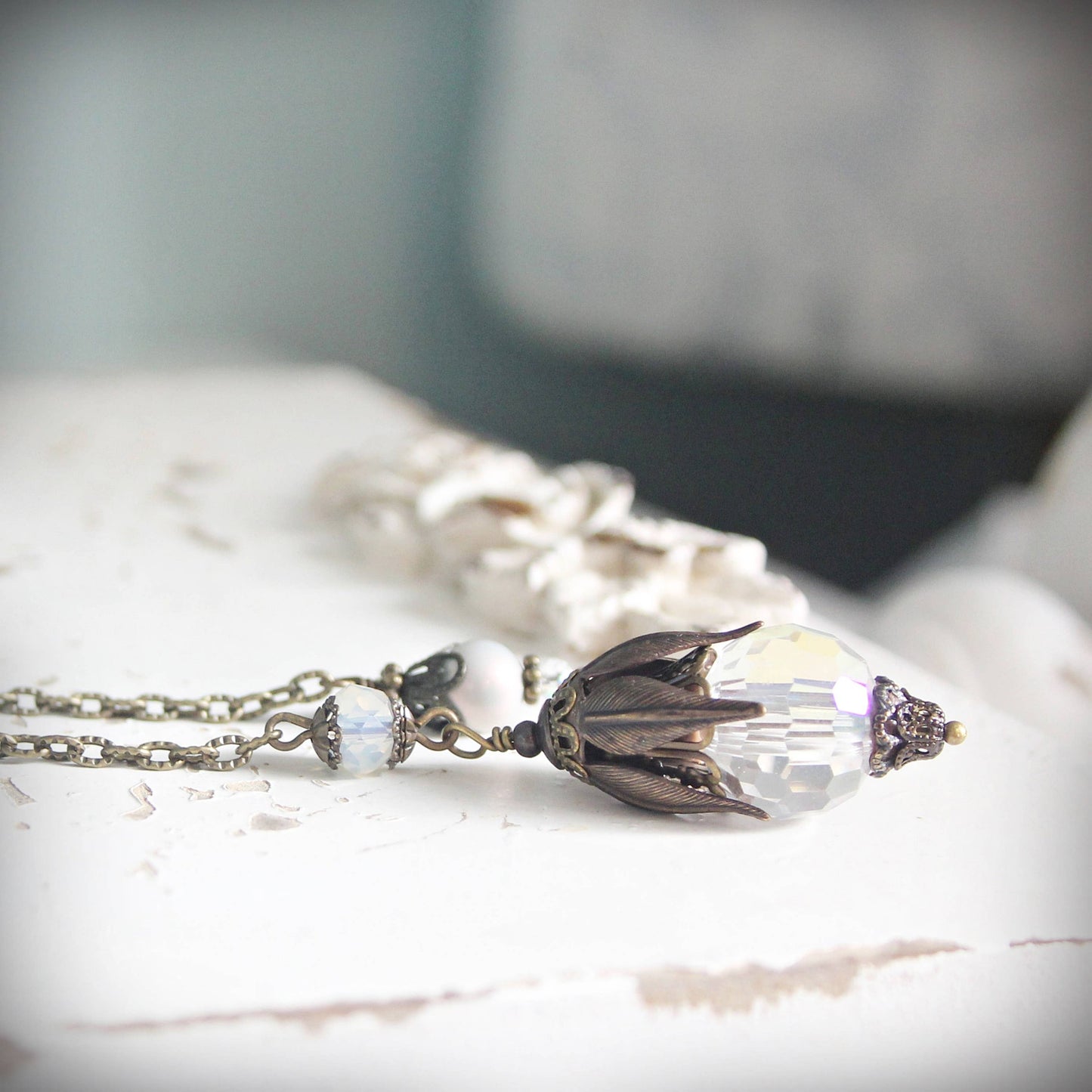 Pendulum with a decorative pendant on a marble surface