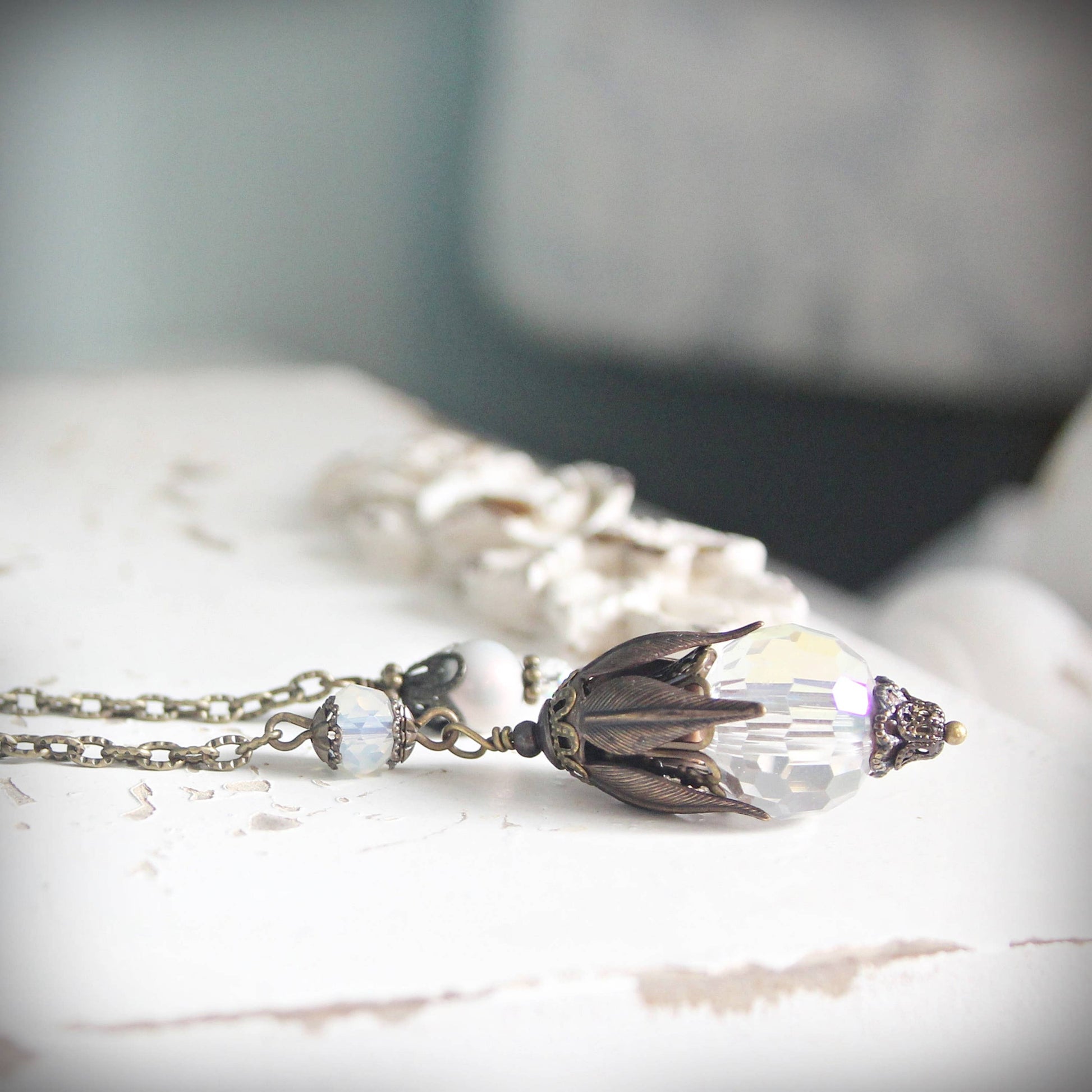 Pendulum with a decorative pendant on a marble surface