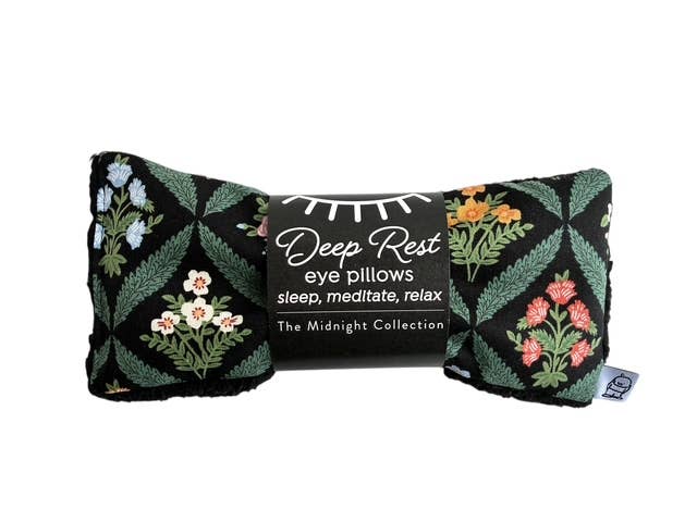 Floral patterned eye pillow with 'Deep Rest' text on a white background