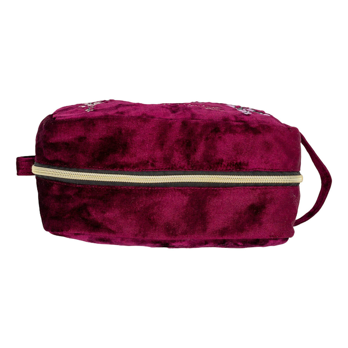 A deep magenta velvet zippered cosmetic bag with a gold zipper and small silver rhinestone embellishments on the top, shown against a plain white background.