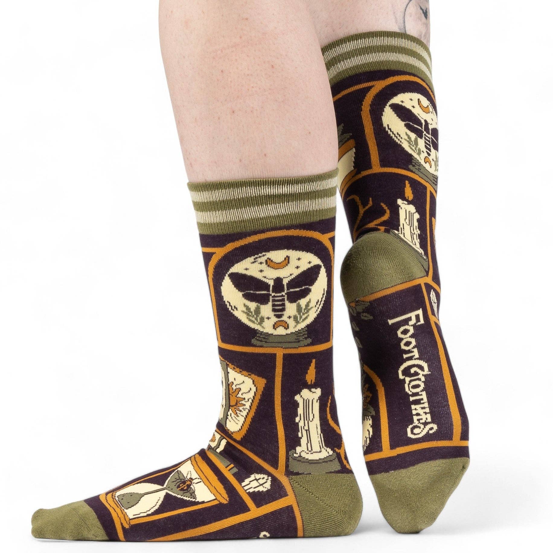Pair of socks with decorative design and 'Footie Clothes' branding on a white background