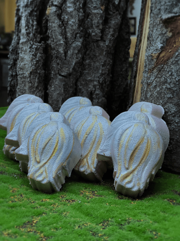 Decorative bath bomb on a grassy area with a tree in the background