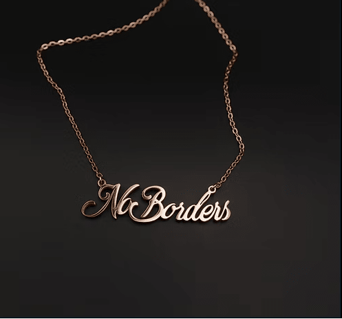 Necklace with 'No Borders' pendant on a dark background