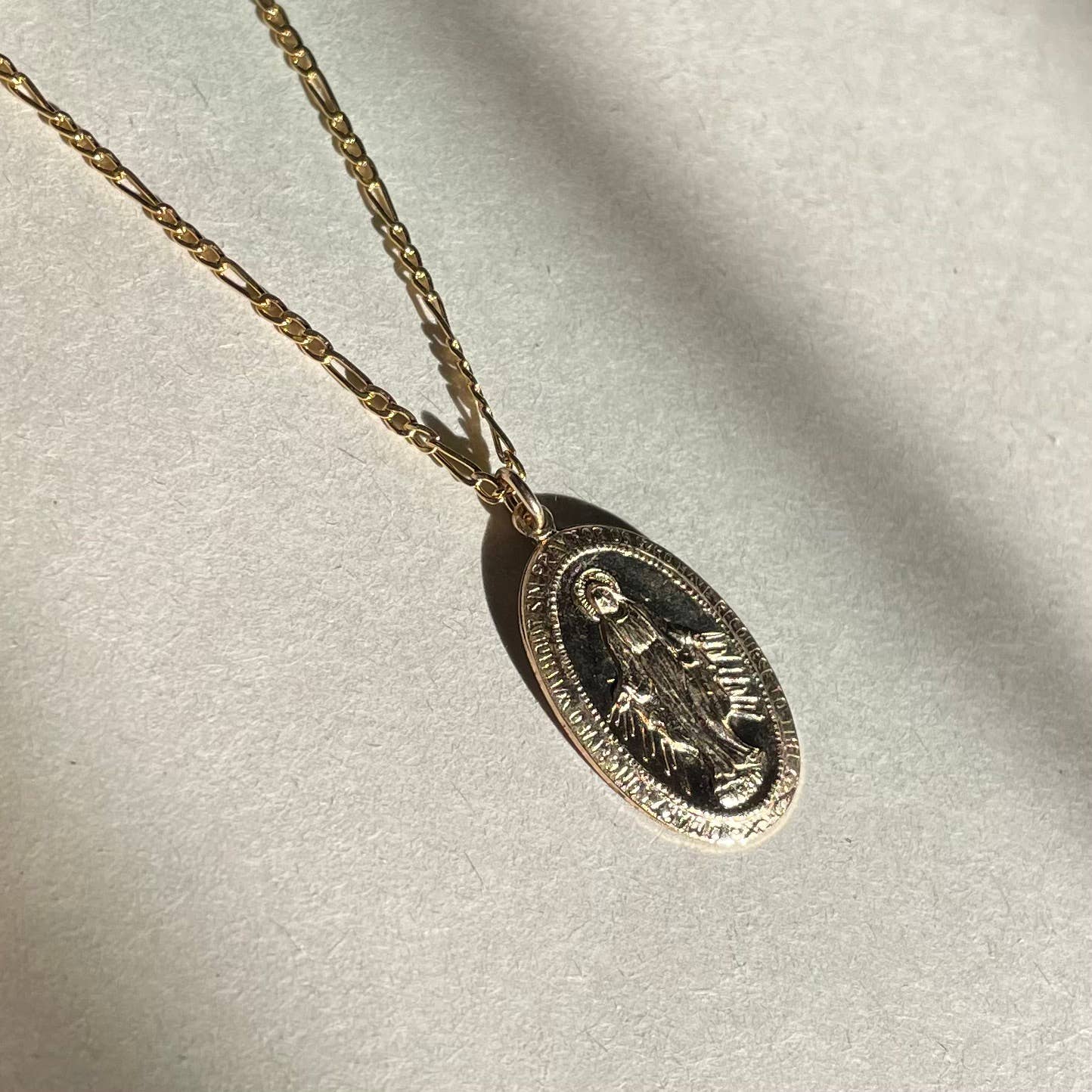 St. Mary gold pendant and chain.
