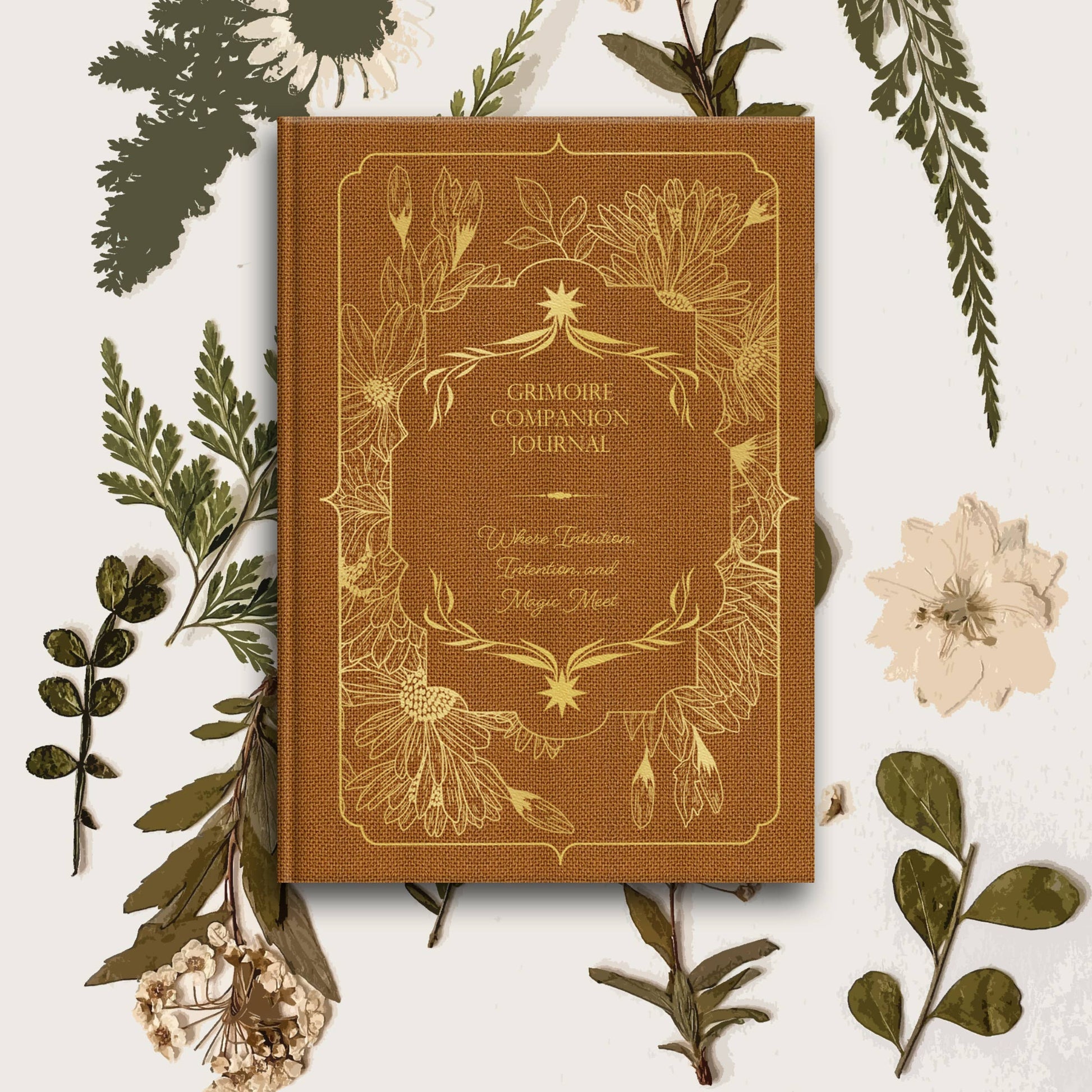 Brown journal titled 'Grimoire Companion Journal' surrounded by green leaves and flowers on a white background