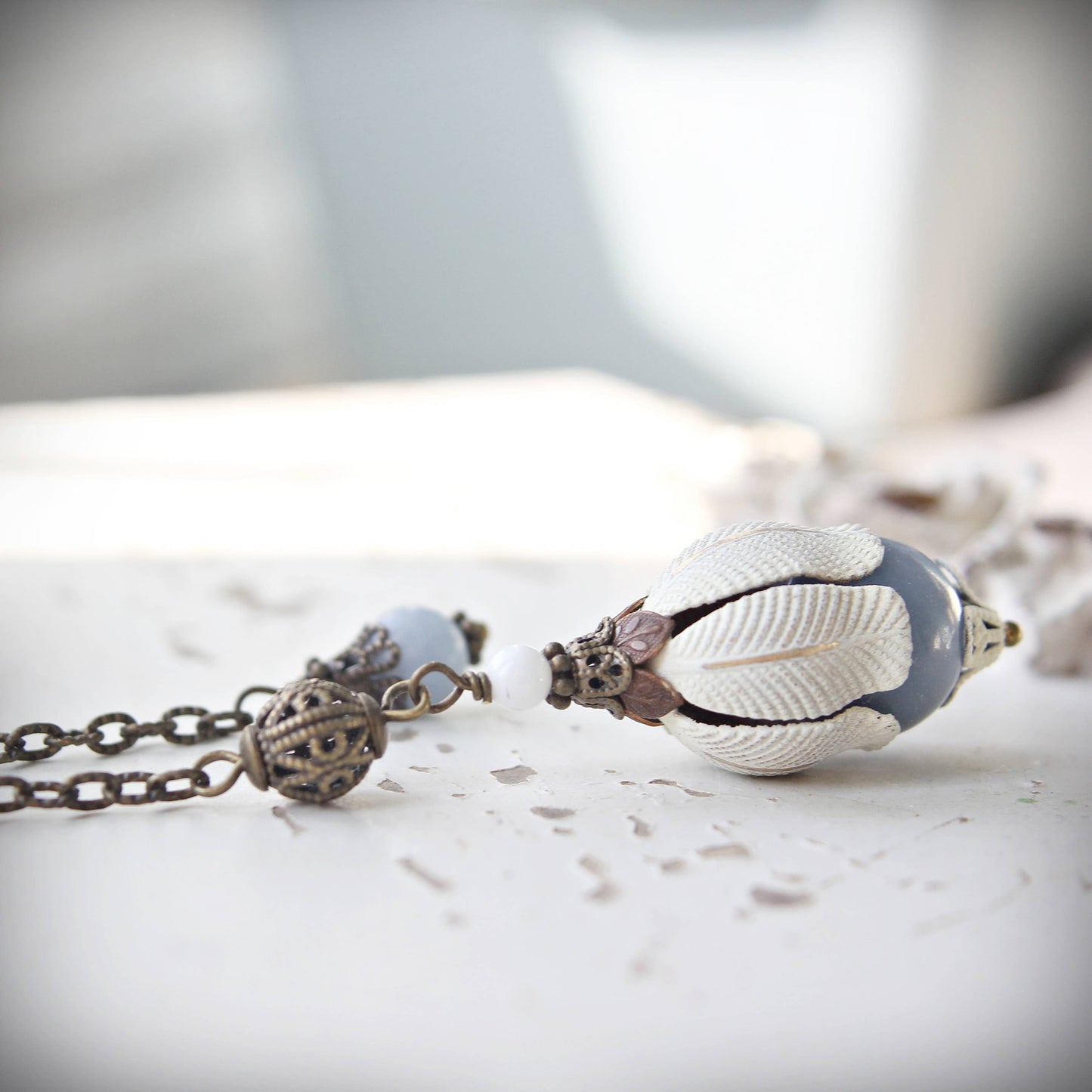 Pendulum with an Agelite stone on a marble surface