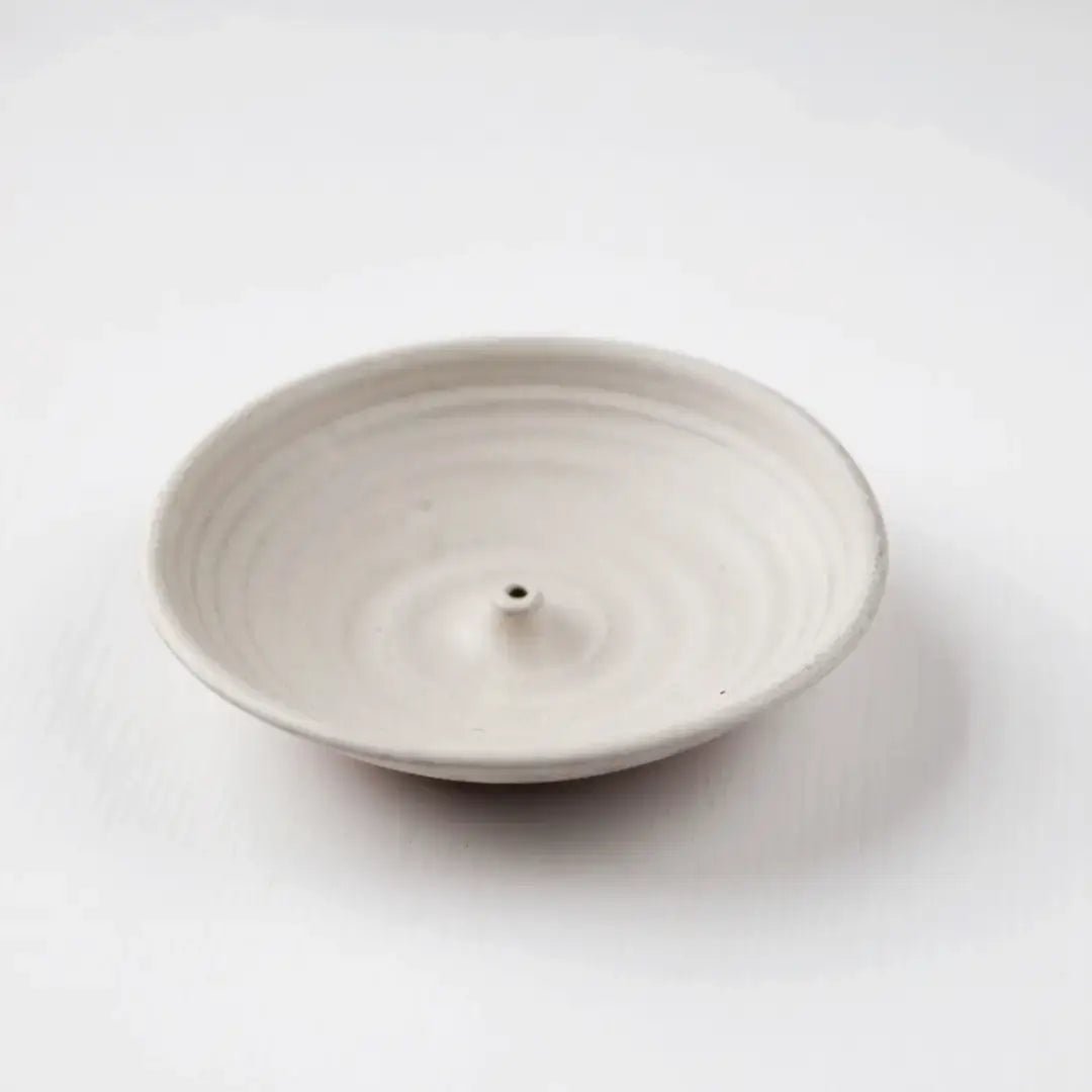 White ceramic incense holder on a white background