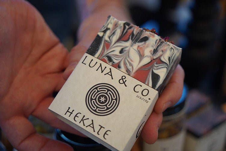 Hand holding a box of Luna & Co Hekate soap with floral design