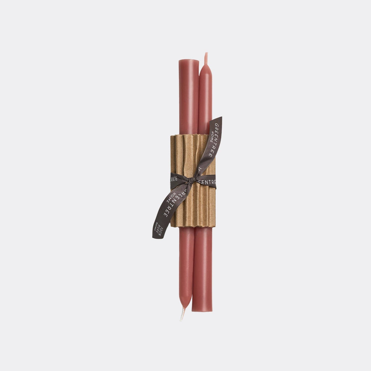 Two slim taper candles in a dusty rose pink color, wrapped together with a textured gold paper sleeve and a black ribbon printed with the brand name 'ENTHUSIAST'.