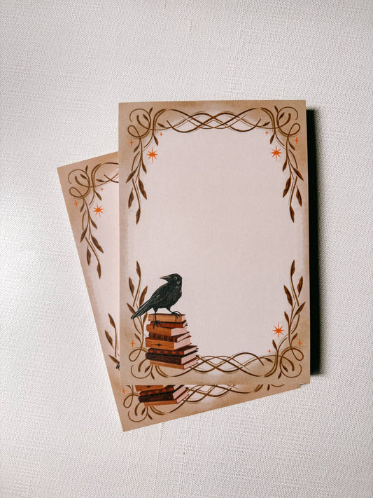 Two decorative notepads with a bird design on a textured surface
