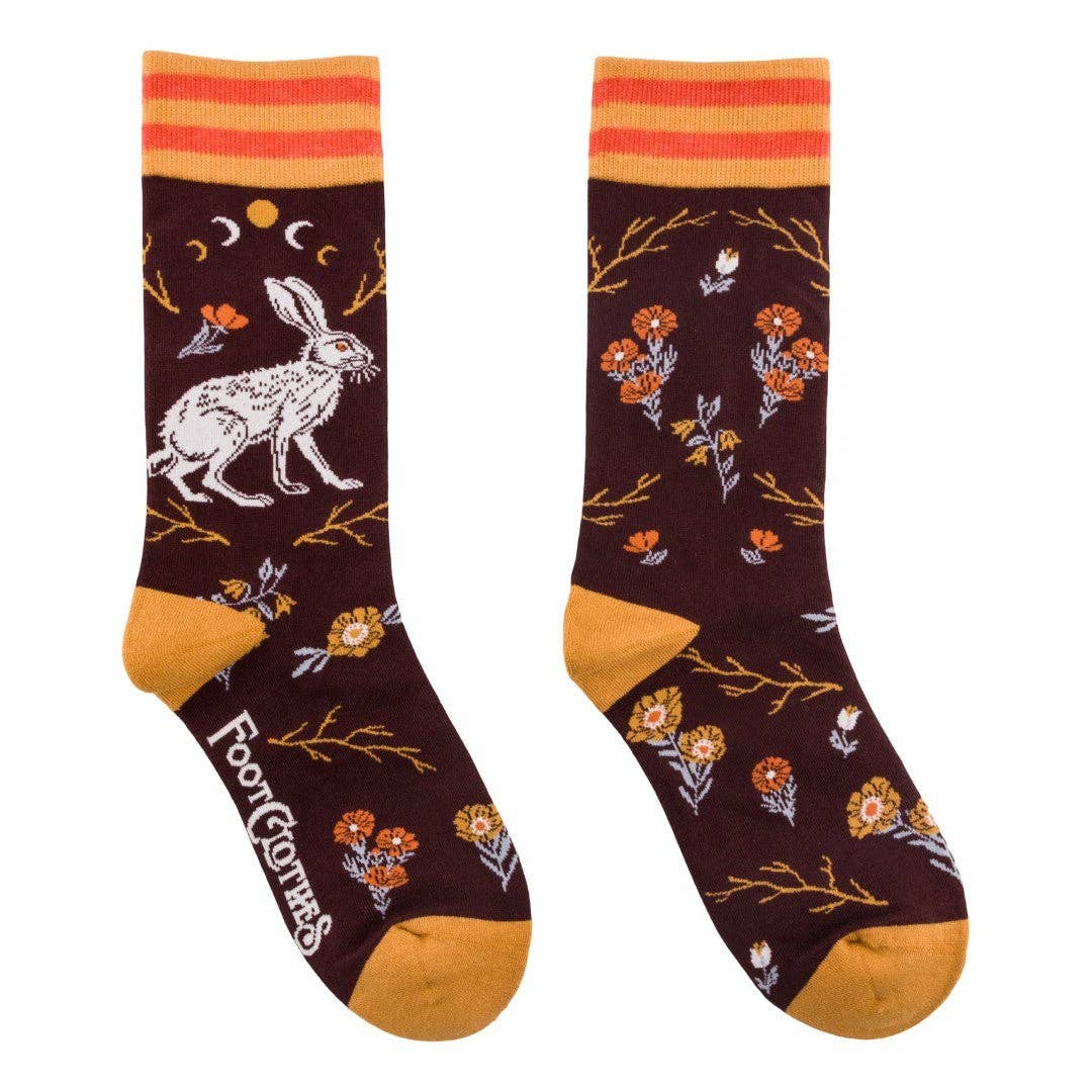 Pair of socks with rabbit and floral design on a white background