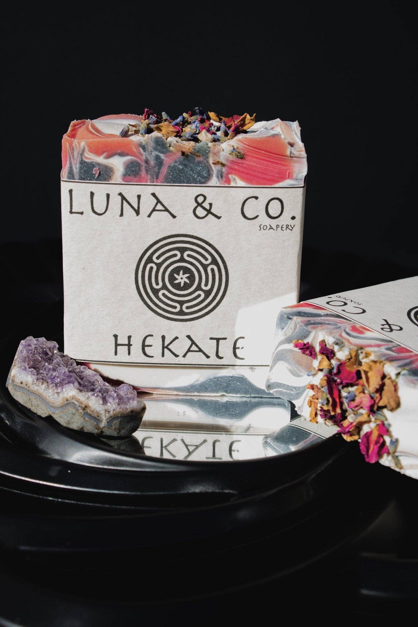 Luna & Co. Hekate soap bar with packaging and decorative elements on a dark background