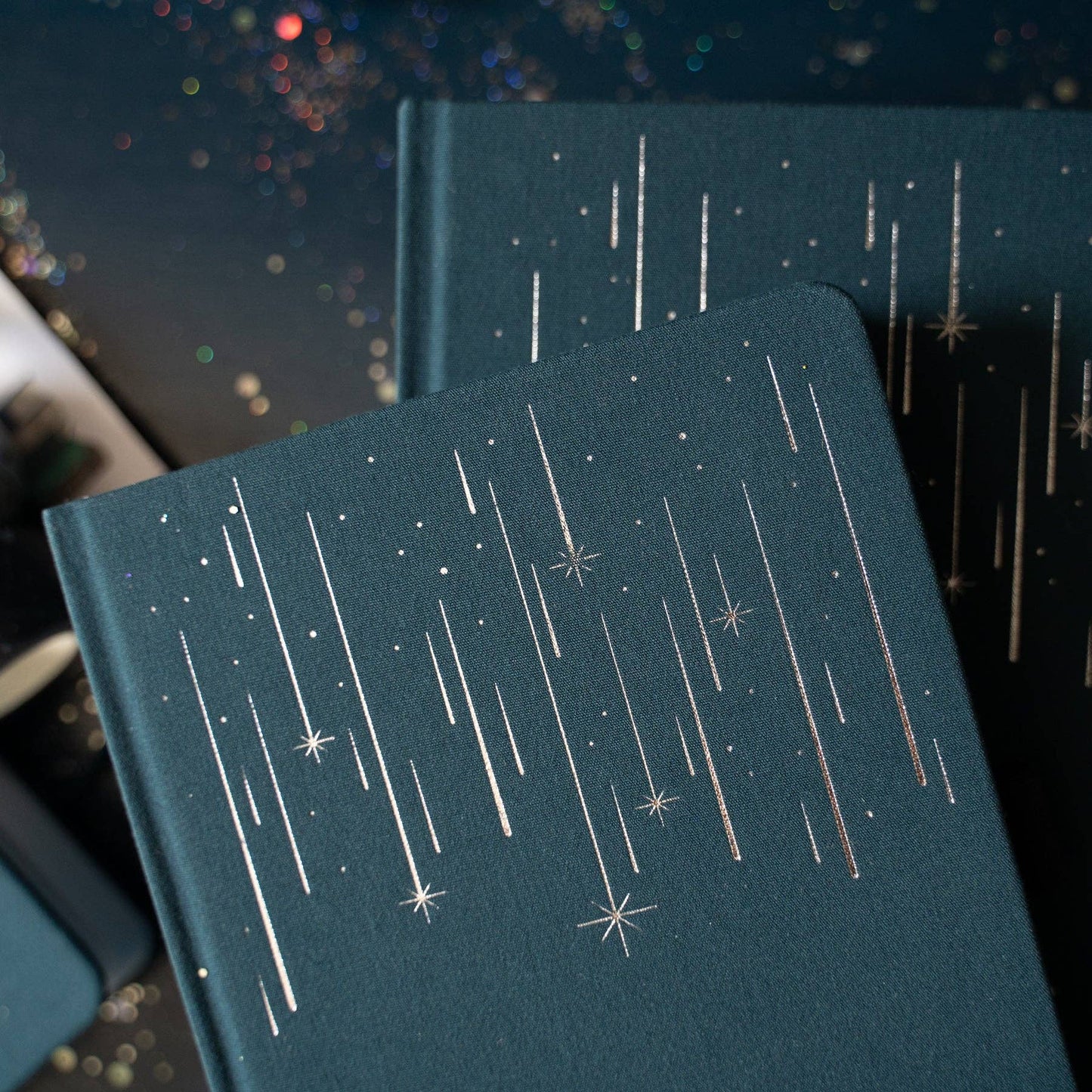 Dark blue notebooks with star pattern on a dark background