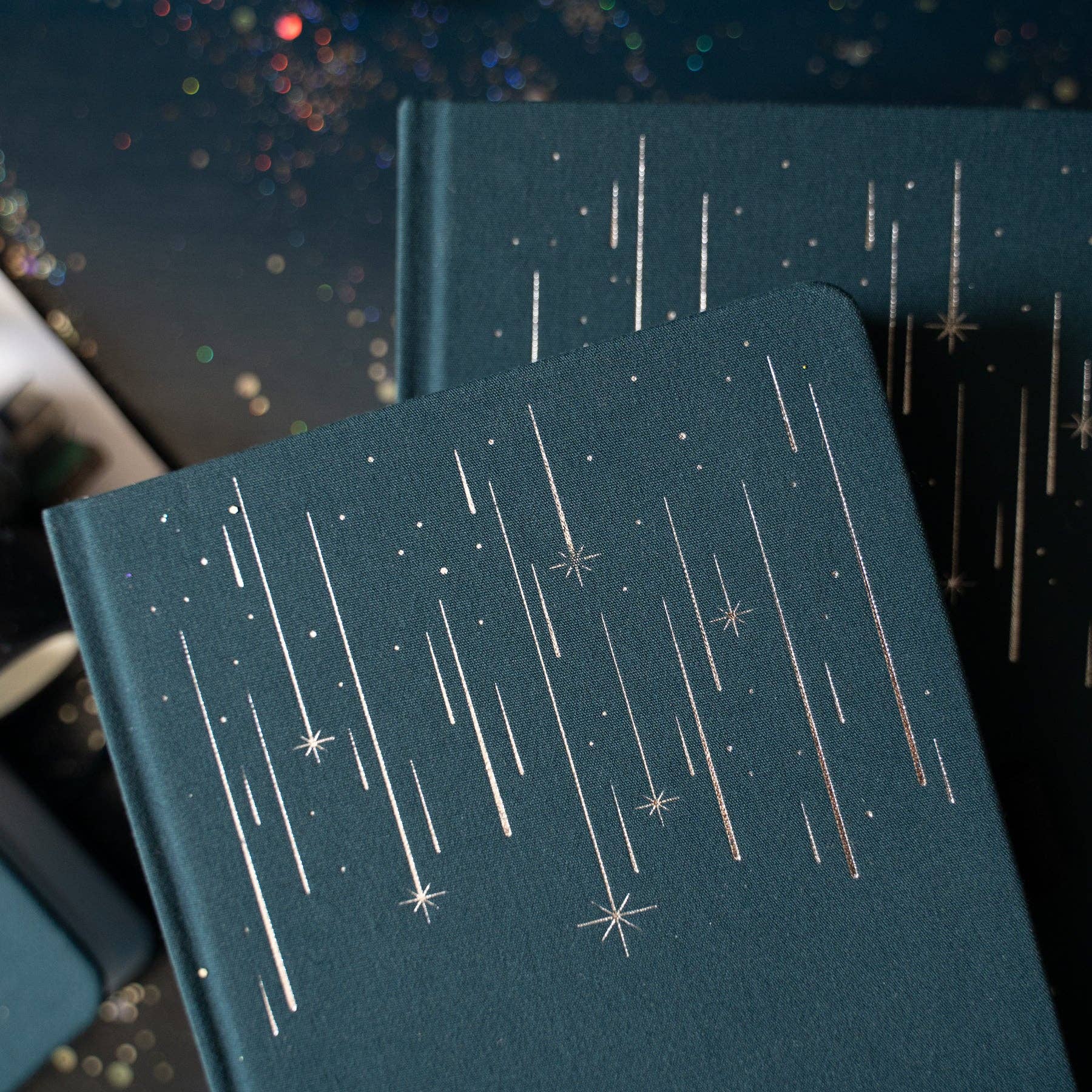 Dark blue notebooks with star pattern on a dark background