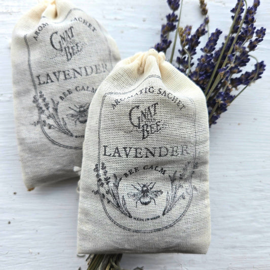 Two lavender sachets with bee design on a white background