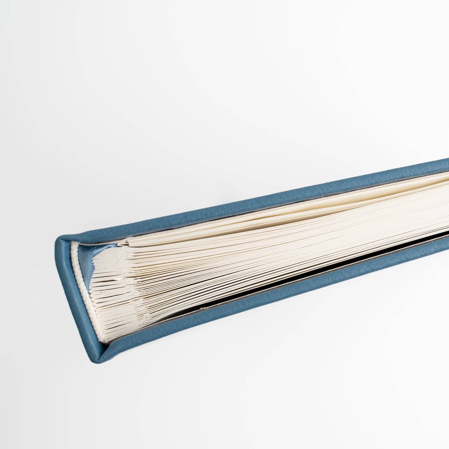 Open book with blue hardcover on a white background