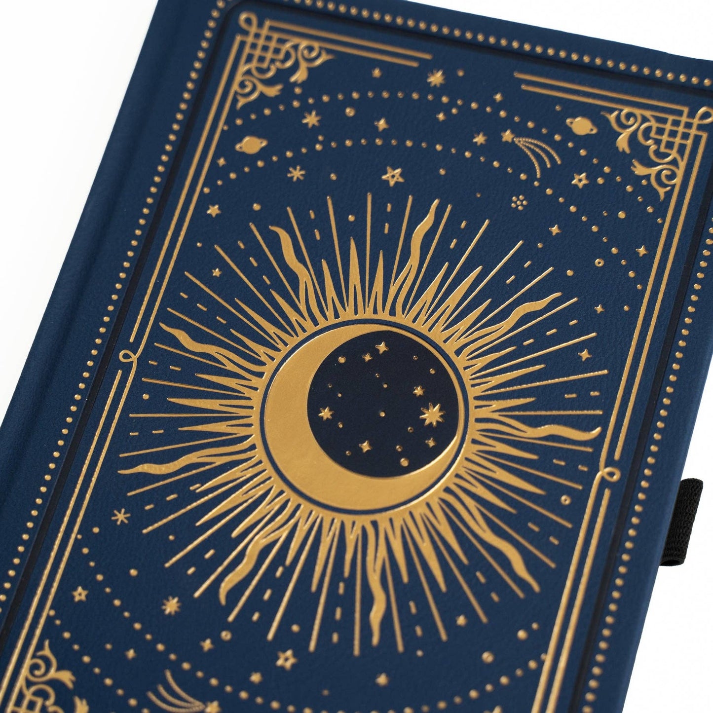 Blue notebook with gold celestial design on a white background